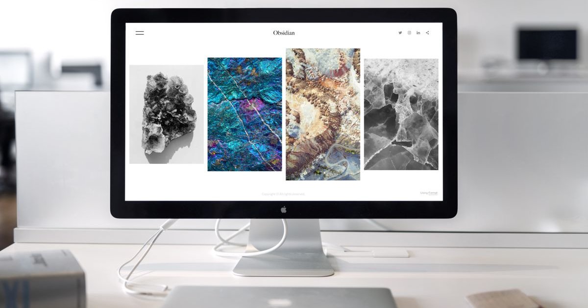 A clean website displayed on a desktop monitor in a workspace